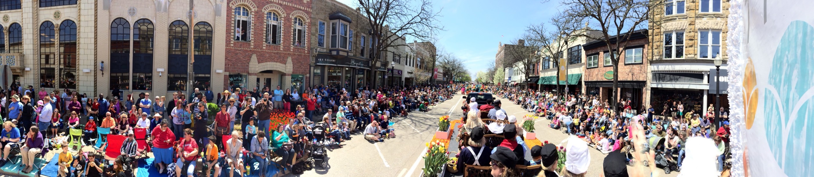 A panoramic shot of a parade crowd taken from a float