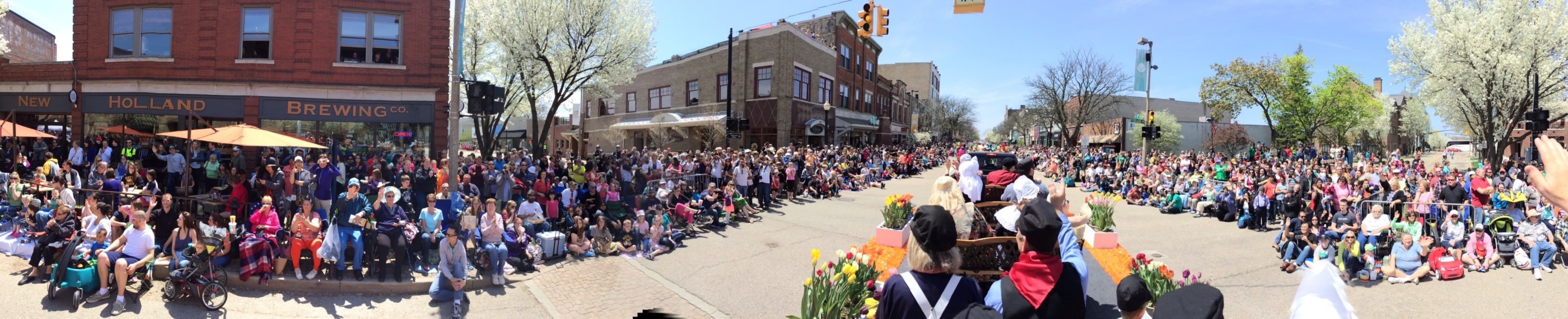 A panoramic shot of a parade crowd taken from a float